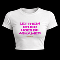 White fitted baby tee with magenta slogan print reading Let Them Other Hoes Be Ashamed, signed @moonlusttees